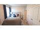 Bedroom showcasing a cozy bed with blue accents, natural light, and closet space at 32313 Conchshell Sail St, Wesley Chapel, FL 33545