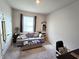 The bedroom features a comfortable couch, desk area, window with blinds and plenty of natural light at 32313 Conchshell Sail St, Wesley Chapel, FL 33545