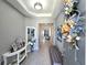 Inviting entryway with a decorative wreath, modern decor, and a glimpse into the spacious interior at 32313 Conchshell Sail St, Wesley Chapel, FL 33545