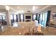 Modern kitchen flows into the living room with a view of dining area; it features granite counters and stainless steel appliances at 32313 Conchshell Sail St, Wesley Chapel, FL 33545