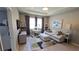 Comfortable living room with a cozy sofa, work station, stylish rug, and natural light at 32313 Conchshell Sail St, Wesley Chapel, FL 33545