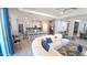 Bright living space featuring open layout, bar stool seating, modern appliances, and view of dining area at 32313 Conchshell Sail St, Wesley Chapel, FL 33545