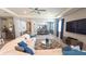 Open-concept living room featuring a sectional sofa, TV, and seamless flow to the dining area at 32313 Conchshell Sail St, Wesley Chapel, FL 33545