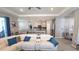 Comfortable living area featuring open layout, bar stool seating, modern appliances, and view of backyard at 32313 Conchshell Sail St, Wesley Chapel, FL 33545
