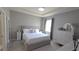 Serene main bedroom with a plush bed, dresser, and neutral color palette at 32313 Conchshell Sail St, Wesley Chapel, FL 33545