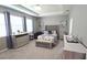 Spacious main bedroom featuring a tufted headboard, dresser, and modern decor at 32313 Conchshell Sail St, Wesley Chapel, FL 33545