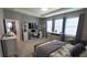 Comfortable main bedroom featuring a desk, TV, and ample natural light at 32313 Conchshell Sail St, Wesley Chapel, FL 33545
