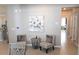 Cozy sitting area with two chairs, small table, and artwork near kitchen at 32313 Conchshell Sail St, Wesley Chapel, FL 33545