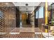 Sleek bathroom with glass enclosed shower, modern fixtures, dark tile, and elegant vanity at 325 2Nd N St, St Petersburg, FL 33701