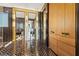 Modern bathroom with black herringbone tile, unique gold-framed mirrors, and wood cabinetry at 325 2Nd N St, St Petersburg, FL 33701