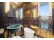 Chic powder room with metallic tile, a unique sink, and a modern toilet at 325 2Nd N St, St Petersburg, FL 33701