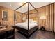 Elegant bedroom with dark wood floors, a four-poster bed, and soft lighting for a relaxing ambiance at 325 2Nd N St, St Petersburg, FL 33701