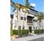 Contemporary three-story home with modern design, clean lines, balcony, and landscaped yard with mature palm trees at 325 2Nd N St, St Petersburg, FL 33701