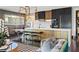 View of kitchen featuring modern black and gold cabinets, island with seating, and stylish light fixture at 325 2Nd N St, St Petersburg, FL 33701