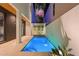 Tranquil pool area with a water feature, set against a modern home with palm trees at 325 2Nd N St, St Petersburg, FL 33701