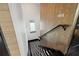 Modern staircase with a black and white geometric patterned runner and wood paneled wall at 325 2Nd N St, St Petersburg, FL 33701