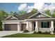 Charming single-story home featuring a two-car garage and a welcoming front porch at 3407 Lumber Falls Dr, Plant City, FL 33565