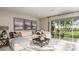 Stylish living room with comfortable seating and a sliding glass door to the backyard at 3408 Lumber Falls Dr, Plant City, FL 33565