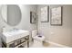 Modern bathroom features a stylish sink, and a toilet, complemented by elegant wall art at 3415 Lumber Falls Dr, Plant City, FL 33565
