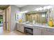 Stylish bathroom with double vanity, granite countertops, large mirrors, and modern fixtures at 3415 Lumber Falls Dr, Plant City, FL 33565