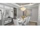 Elegant dining room with modern chandelier, tray ceiling, artwork, and seating for six at 3415 Lumber Falls Dr, Plant City, FL 33565