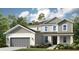 Charming two-story home with a gray garage, complemented by lush landscaping and an inviting entrance at 3415 Lumber Falls Dr, Plant City, FL 33565