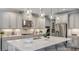 Spacious kitchen with a large center island, stainless steel appliances, and modern light-gray cabinetry at 3415 Lumber Falls Dr, Plant City, FL 33565