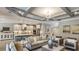Open-concept living room featuring stylish furniture, a modern kitchen, and elegant decor at 3415 Lumber Falls Dr, Plant City, FL 33565