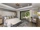 Luxurious primary bedroom features a king bed, tray ceilings, and sliding doors to the patio at 3415 Lumber Falls Dr, Plant City, FL 33565