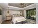 Luxurious main bedroom featuring elegant decor, tufted headboard, and access to outdoor space at 3415 Lumber Falls Dr, Plant City, FL 33565