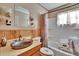 Bathroom features a unique sink and vanity, combined shower and tub, wood wall panels at 4102 Haines N Rd, St Petersburg, FL 33703