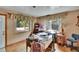 Sunlit bedroom featuring wood floors, floral curtains, and multiple windows at 4102 Haines N Rd, St Petersburg, FL 33703