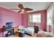 Modest bedroom with pink walls, light wood floors, window and unique leaf-shaped ceiling fan at 4102 Haines N Rd, St Petersburg, FL 33703
