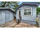 Exterior view of house featuring shed, access door, and steps to front door at 4102 Haines N Rd, St Petersburg, FL 33703