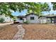 Comfortable one-story home with a pathway leading to the entrance, set in a tranquil residential environment at 4102 Haines N Rd, St Petersburg, FL 33703