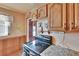 Traditional kitchen features wood cabinets, tile countertops, and an electric range at 4102 Haines N Rd, St Petersburg, FL 33703