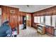 Room with wood paneling, tile floors, built-in shelves, and a small table at 4102 Haines N Rd, St Petersburg, FL 33703