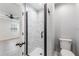 Modern bathroom featuring a glass-enclosed shower with sleek marble tiles and contemporary fixtures, adjacent to main bedroom at 4307 Woodfield Ave, Holiday, FL 34691