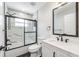 Modern bathroom with black and white marble tile in shower and on walls plus black trim and fixtures at 4307 Woodfield Ave, Holiday, FL 34691