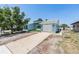 Attractive light blue one-story home showcasing a well-maintained lawn, a driveway, and an attached garage at 4307 Woodfield Ave, Holiday, FL 34691
