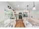 Well-lit kitchen featuring white cabinetry, stainless steel appliances, granite countertops, and modern pendant lighting at 4307 Woodfield Ave, Holiday, FL 34691