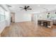Bright, open-concept living area with hardwood floors, opening to the kitchen with stainless steel appliances and breakfast bar at 4307 Woodfield Ave, Holiday, FL 34691