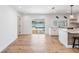 Open living and kitchen space with hardwood floors and sliding doors leading to the pool in a bright and inviting home at 4307 Woodfield Ave, Holiday, FL 34691
