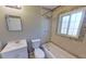 Bathroom featuring a shower-tub combo with decorative tile and a large window at 4331 Fairfield S Ave, St Petersburg, FL 33711