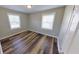 Bedroom featuring wood floors, light walls, and two windows at 4331 Fairfield S Ave, St Petersburg, FL 33711