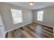 Bedroom with wood floors, two windows, and neutral colored walls at 4331 Fairfield S Ave, St Petersburg, FL 33711