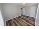 Bedroom with wood floors, light walls, open door, and bright natural light at 4331 Fairfield S Ave, St Petersburg, FL 33711