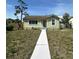 Charming single story home features a green exterior, well-maintained lawn, and inviting front walkway at 4331 Fairfield S Ave, St Petersburg, FL 33711