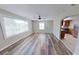 Bright living room with wood floors, ceiling fan, and a view into the kitchen at 4331 Fairfield S Ave, St Petersburg, FL 33711