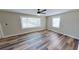 Bright living room with new wood floors, two large windows and neutral colored walls at 4331 Fairfield S Ave, St Petersburg, FL 33711